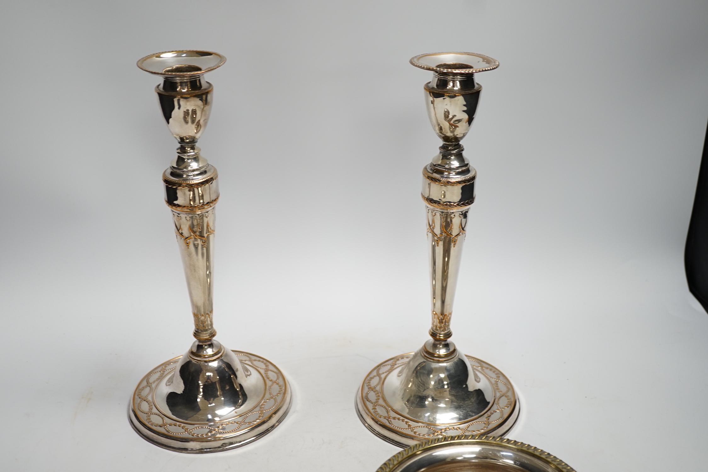 A pair of 19th century silver plated candlesticks and a pair of coasters, tallest 28cm